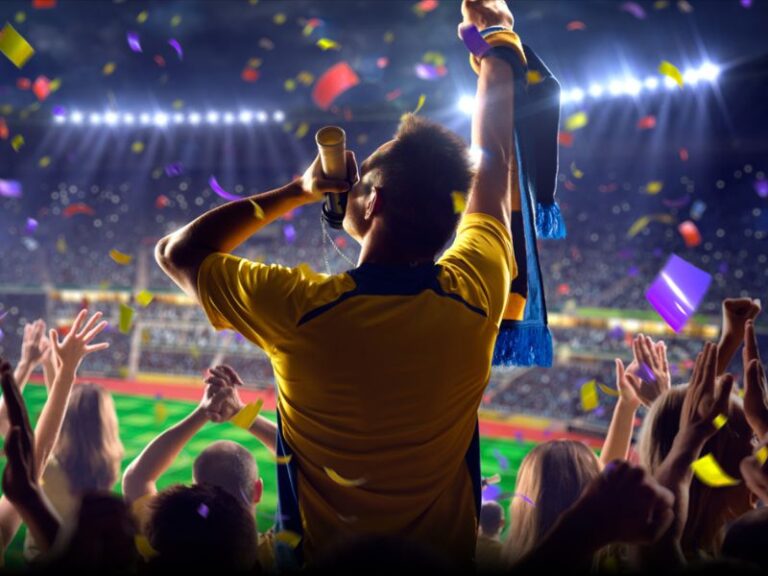Sports fan with trophy celebrating