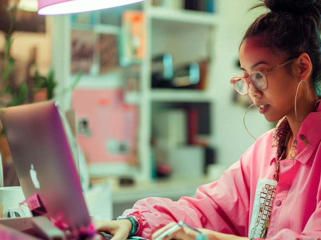 Asian woman Gen Z at work on a laptop